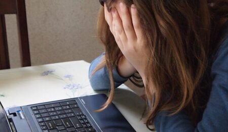 laptop-writing-hand-table-person-girl-hair-child-black-conversation-sad-face-hands-head-tired-organ-her-interaction-bullying-sense-human-action-curl-up-896222-scaled-e1669409743518.jpg